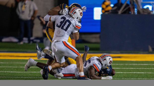 Sep 9, 2023; Berkeley, California, USA; California Golden Bears running back Isaiah Ifanse (22) fumbles the football recovered by Auburn Tigers linebacker Jalen McLeod (35) during the second quarter at California Memorial Stadium. Mandatory Credit: Neville E. Guard-USA TODAY Sports  